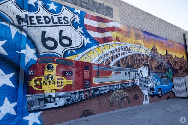 Adorning Needles Regional Museum, the vibrant mural unfurls tales of the town's past.