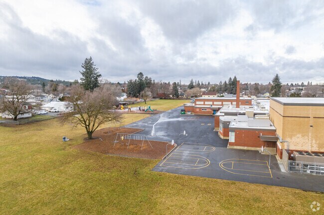 Ness Elementary has multiple playgrounds behind the school.