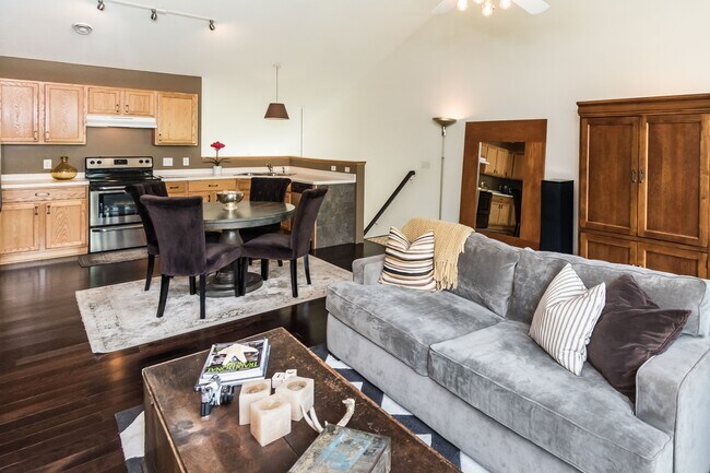 Open concept kitchen and living room with vaulted ceilings.