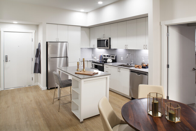 Phase II - Scheme C Kitchen with white cabinetry, grey tile backsplash, and stainless steel appliances