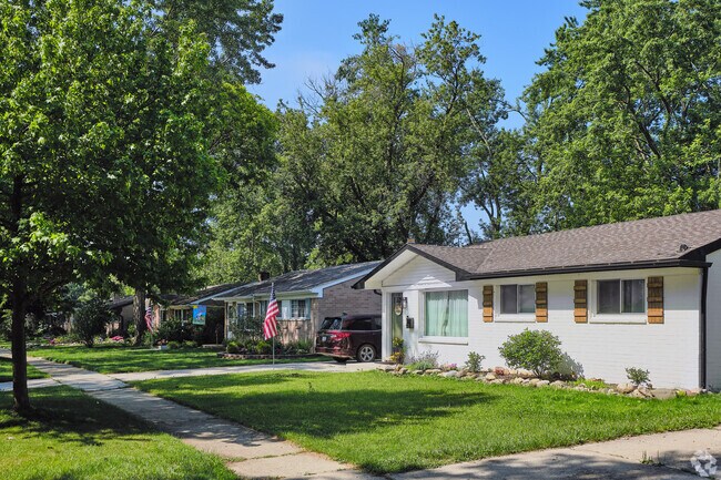 A row of single-family ranch houses lines a shady street in South Side.
