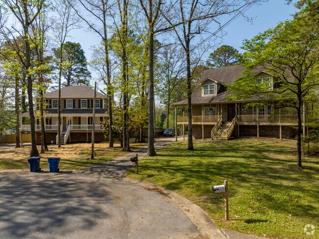 Prairie-style homes nestle among trees that shade and cool them during Alabama summers.