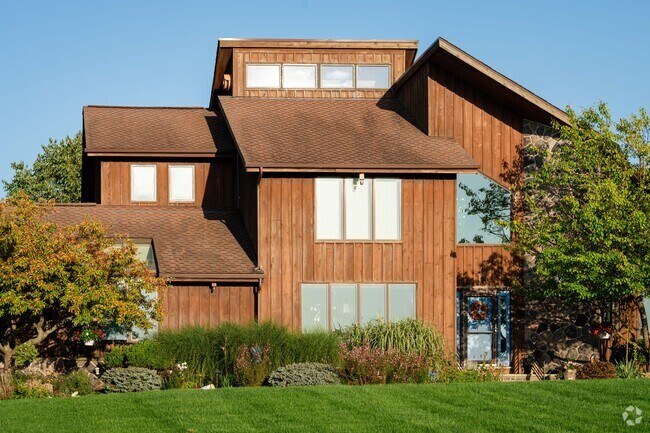 This wooden home in Grand Island blends in with nature with its natural tones.