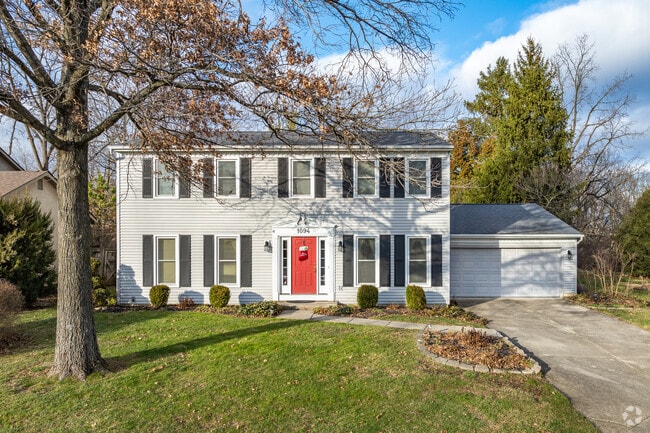 A colonial style home in The Gables neighborhood features an attached two-car garage.