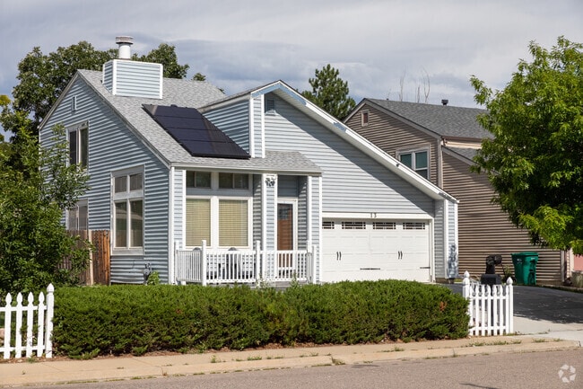 This split-level home has a two-car garage and a picket fence in Highline Village.