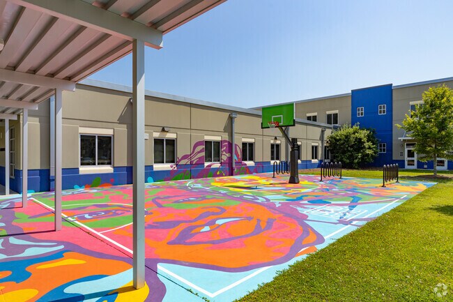 The colorful basketball court catches the eye of students at the Hodge Elementary School.