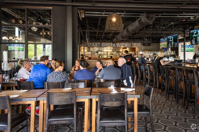 In the heart of Shippeetown, RI, locals savoring delectable dishes at Tavern in the Square.