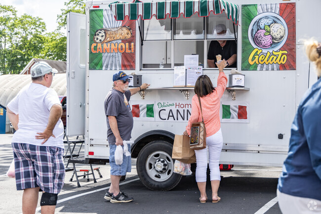 Couples enjoy a cold treat on a hot day while walking around the Canonsburg Farmers Market.