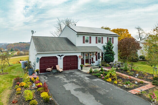 Fall foliage frames this Hamburg residence, offering a warm welcome to the beauty of the season.