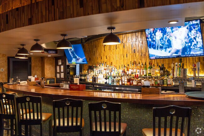 Sit at the bar and order sushi and drinks at Sushi Masa in Acadiana Wood, Lafayette.