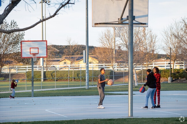 Teens hang out and play basketball at Crown Valley Park near Winchester-Silverhawk.
