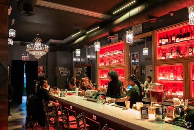 Residents enjoy a night out at one of the bars in Mott Haven.