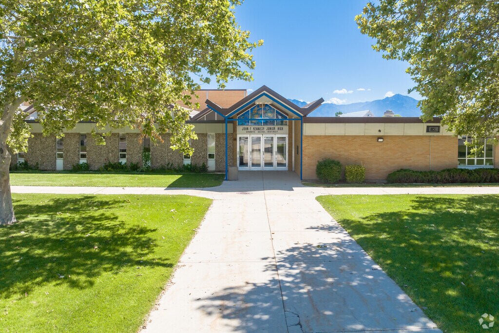 John F. Kennedy Junior High School has shade trees by the entrance.