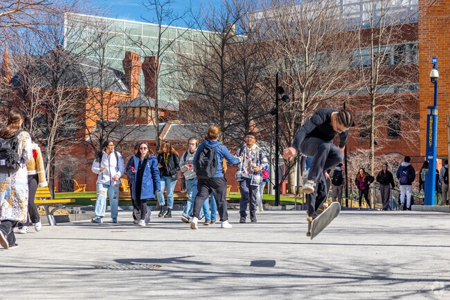Skaters and students roll through Korman Family Quad in University City.