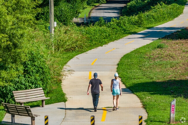 People stroll down the Stone Mountain Path trail in the Scottdale neighborhood.