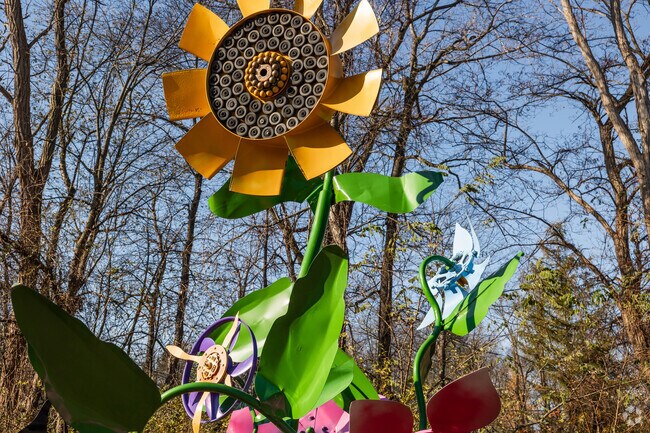 A large, metal sunflower statue can be seen at the front of Reinstein Woods Nature Preserve.