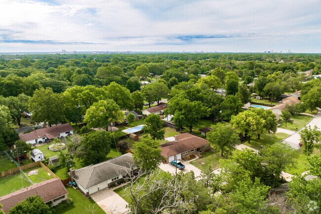Most homes in Sherwood Glen are surrounded by tall trees.
