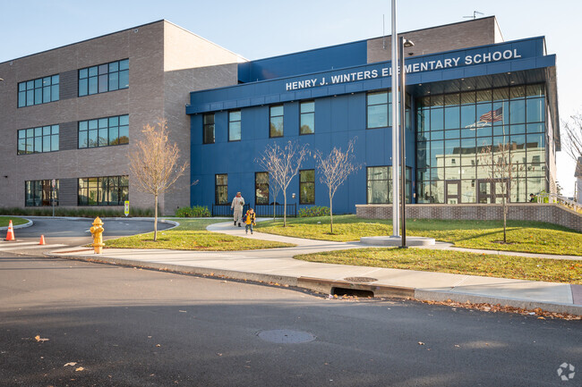 A parent leaving with his child from Henry J. Winters Elementary School in Pawtucket.