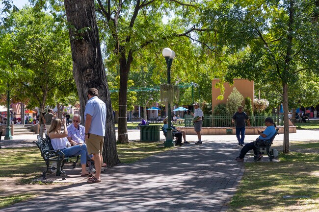 People lounge about in Historic Santa Fe Plaza near Agua Fria.