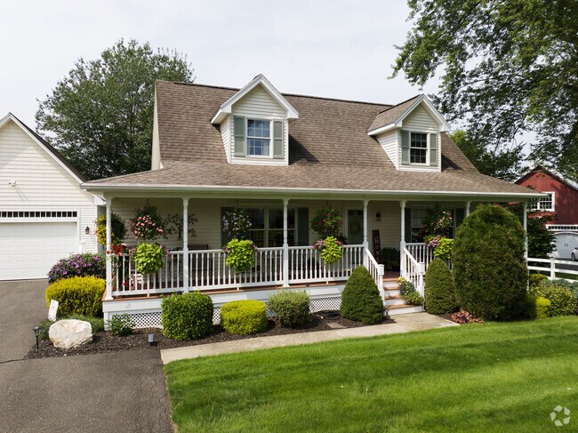 Modern country homes have big porches in South Hadley.