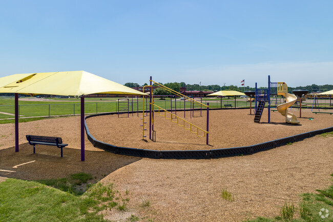 There is shaded seating around the playground at Desoto Central Elementary School.