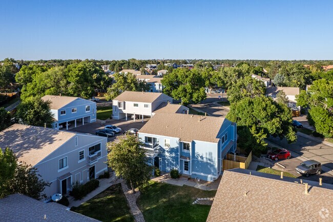 Homes in a grouping of four share green spaces and parking lots in Westdale, Arvada.