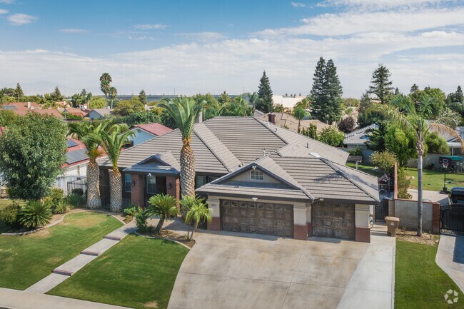 Palm trees grow high above the roof of a home in The Seasons neighborhood.