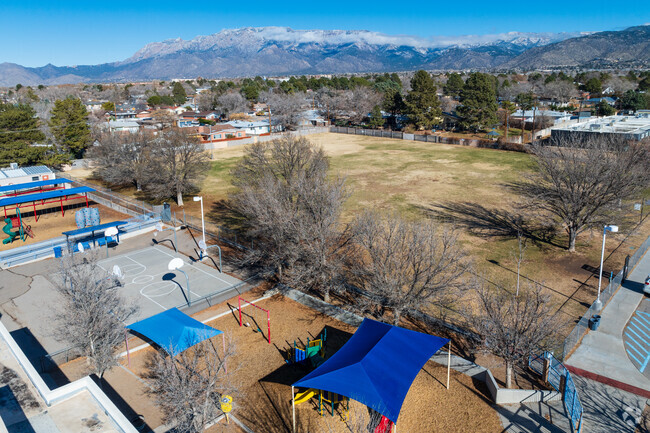 Mitchell Elementary School's grass field with Sandia Mountain views.