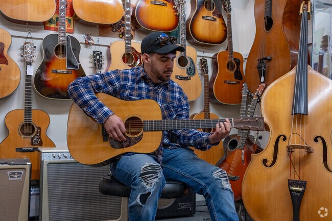 You can pick a guitar and play it right off the wall at Lark St. Music in Teaneck.