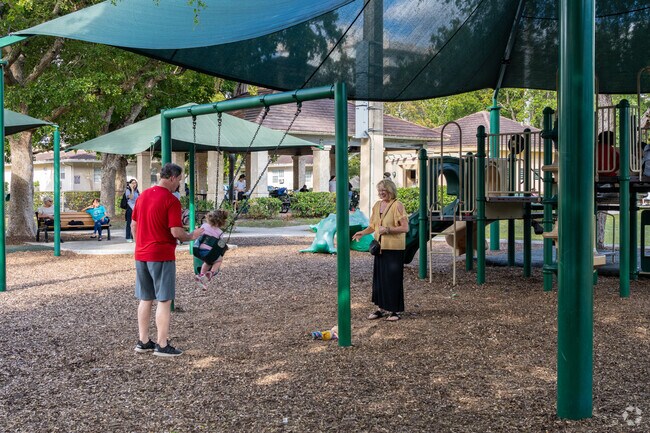 A family enjoys the swing in Philips Park in Douglas.