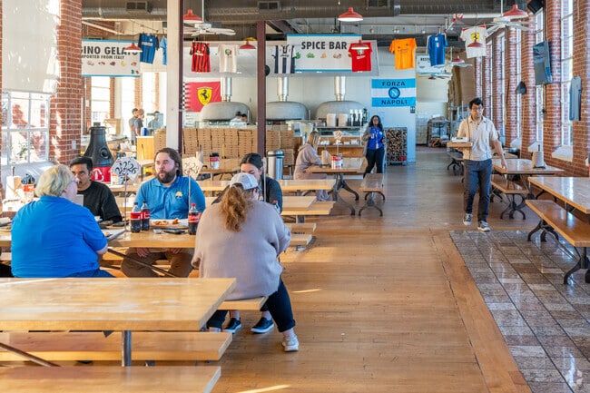 Enjoy a slice of pizza at Cugino Forno Pizzeria at Revolution Mill in White Oak.