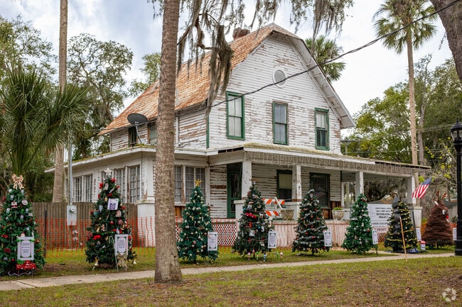 A large historic home in the center of Green Cove Springs is surrounded by Christmas trees.