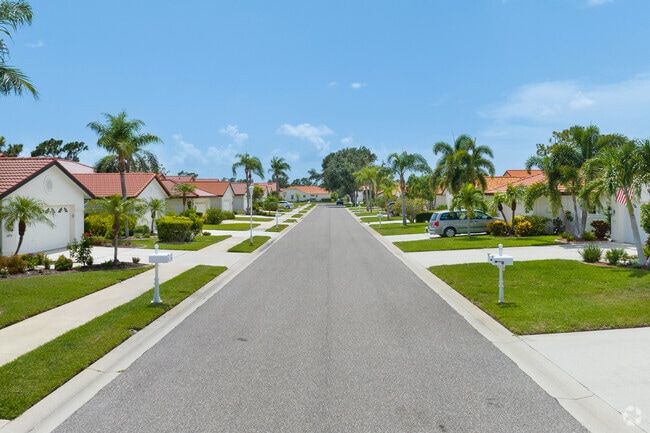 Low level aerial perspective looking down quiet Venice East neighborhood street.