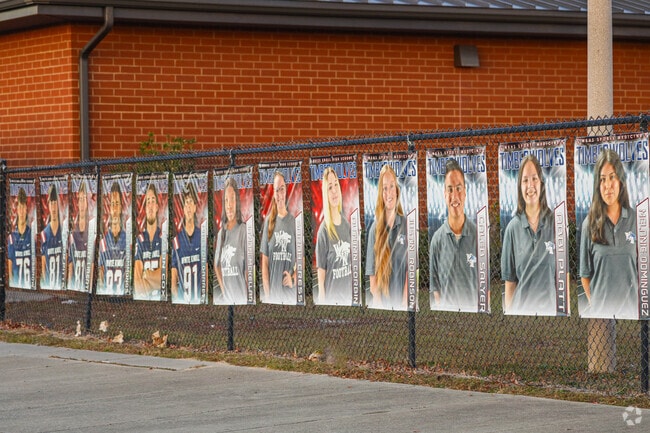 Athletes are celebrated with giant posters lining the athletic field at White Knoll High School.