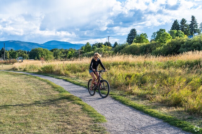 A biker makes her way to the Gallagator Linear Trail that passes near Bozeman Creek.