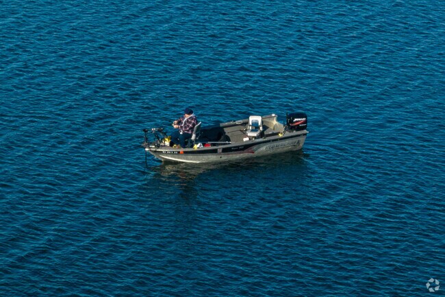 A Powers Lake resident enjoys fishing out on his boat.