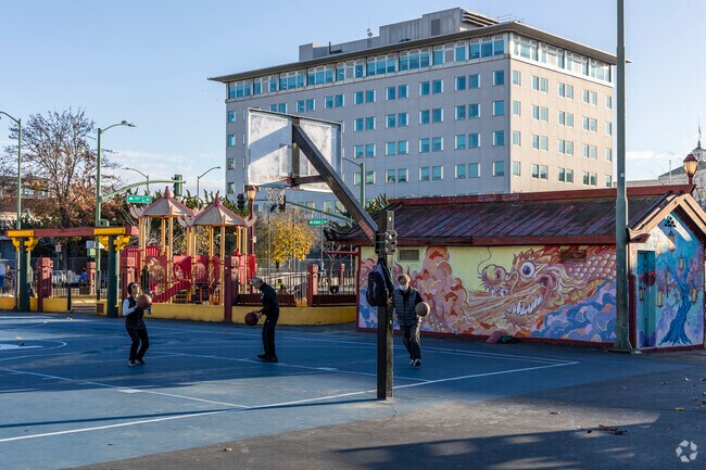 The basketball courts in Lincoln Square Park are active all day long.