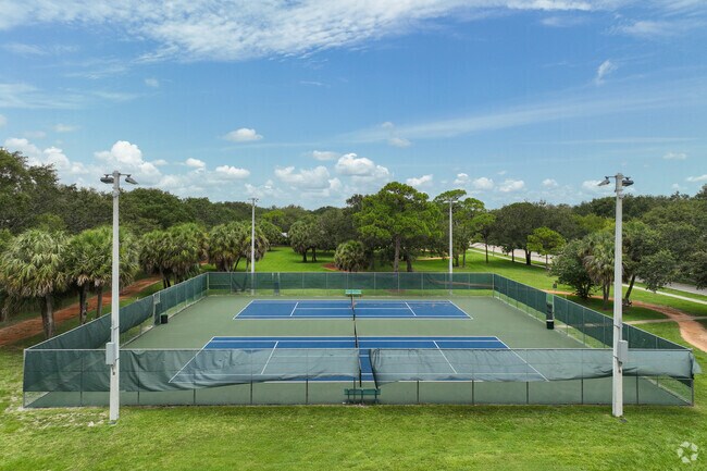 Tennis courts at Oaks Park offer recreation under tropical skies.