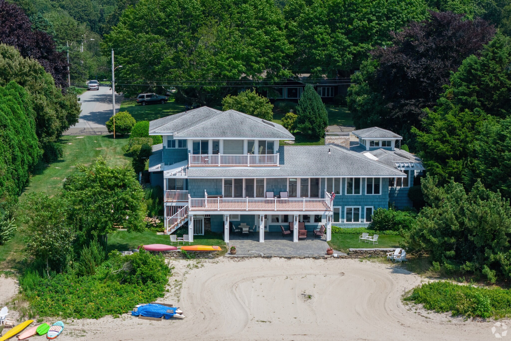 Three layers of beautiful sunset views grace this Mumford Cove home.