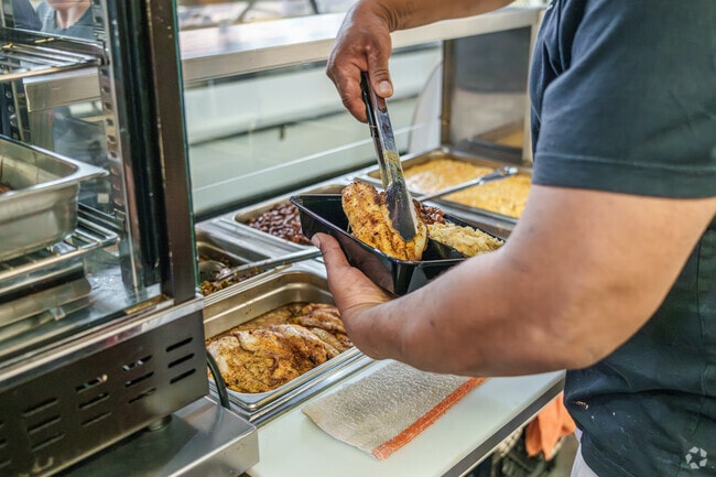 A vendor at Downtown Lancaster's Central Market preps tasty lunches for locals.