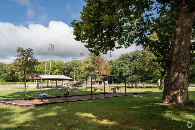 The play set at Plano City Park is shaded nicely by large oak trees.