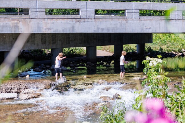 Residents cool off splashing through Jordan Creek in the Ewing neighborhood.