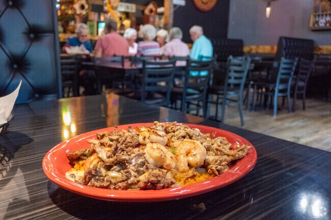 Residents gather at Riverside Bar & Restaurant for classic wings and burgers in Watertown.
