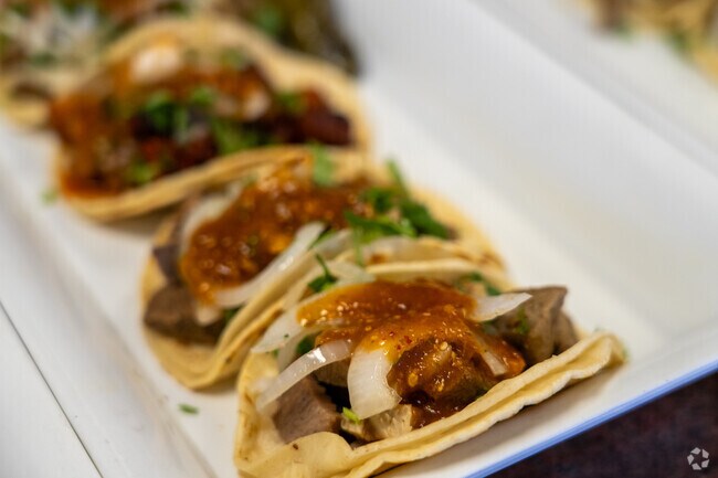 Savoring the mouthwatering tacos at Ranchero Taqueria, a flavor explosion in every bite.