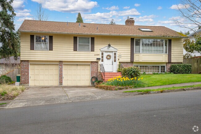 A quintessential colonial revival home with freshly blossomed daffodils in Vose Beaverton.