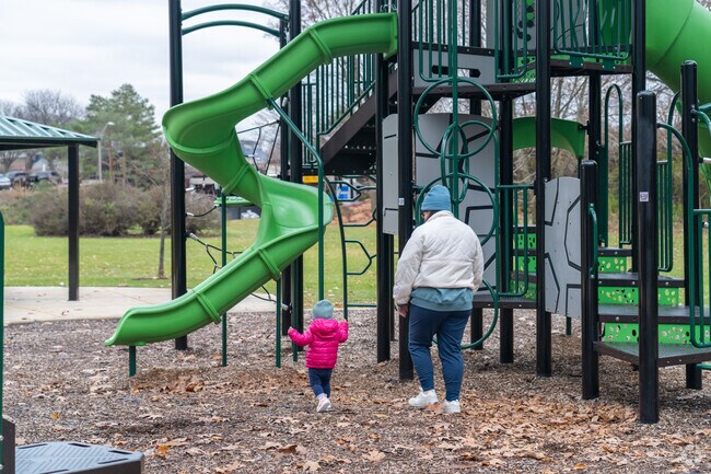 A Naperville resident plays with their child at North Downtown Naperville's Kendall Park.