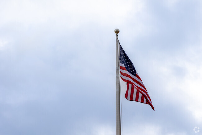A brilliant American flag stands outside of Point Webster Middle School in Quincy.