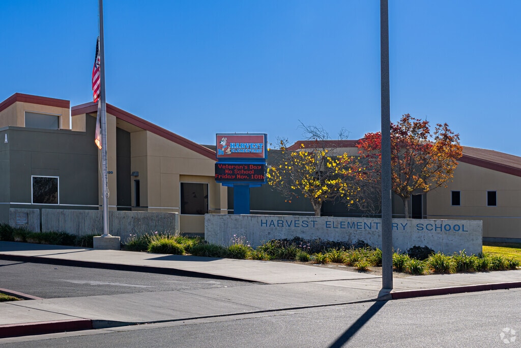 An American flag waves outside the entrance to Harvest Elementary School in Delano.