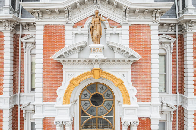 Lady Justice stands high above the county courthouse arch holding her sword, scales and a smirk in Van Wert.