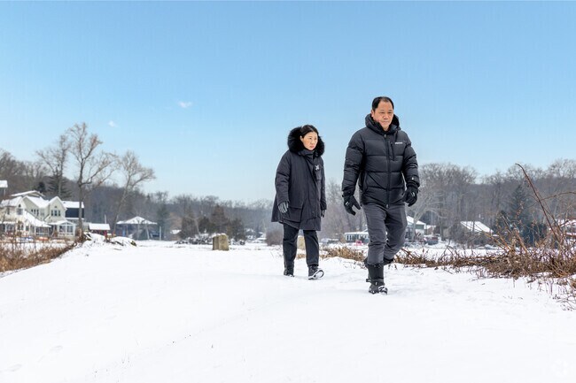 Byram residents take a peaceful stroll along the lake, enjoying the scenic waterfront views.